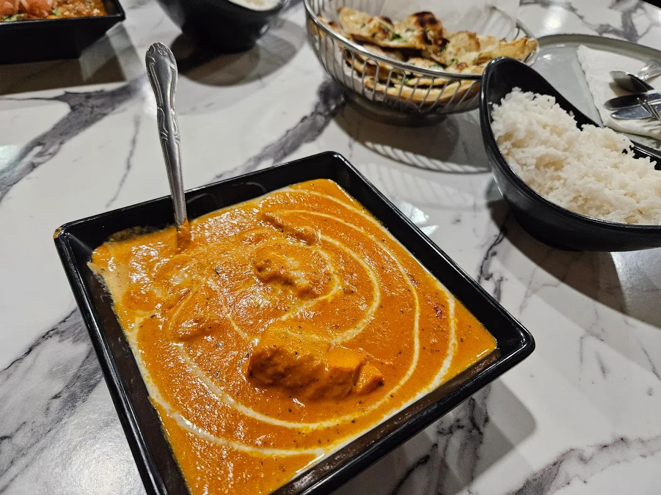 Butter chicken with naan and basmati rice at Curry NaanStop